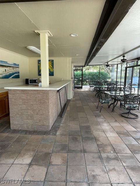 view of patio featuring ceiling fan and an outdoor bar