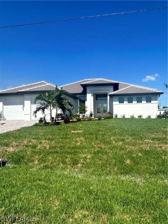 view of front of house with a garage and a front yard