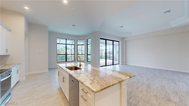 kitchen featuring light stone countertops, appliances with stainless steel finishes, a center island with sink, and sink