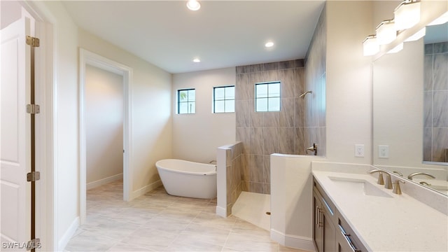 bathroom featuring shower with separate bathtub, vanity, and tile patterned floors