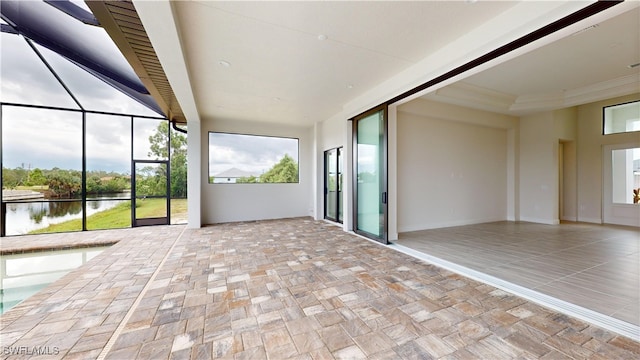 unfurnished sunroom featuring a water view