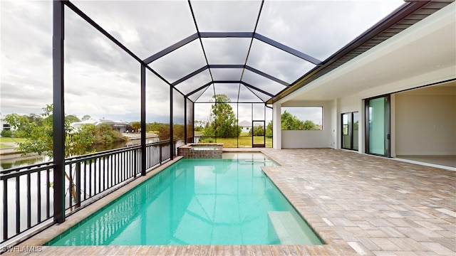 view of pool featuring glass enclosure, an in ground hot tub, a water view, and a patio