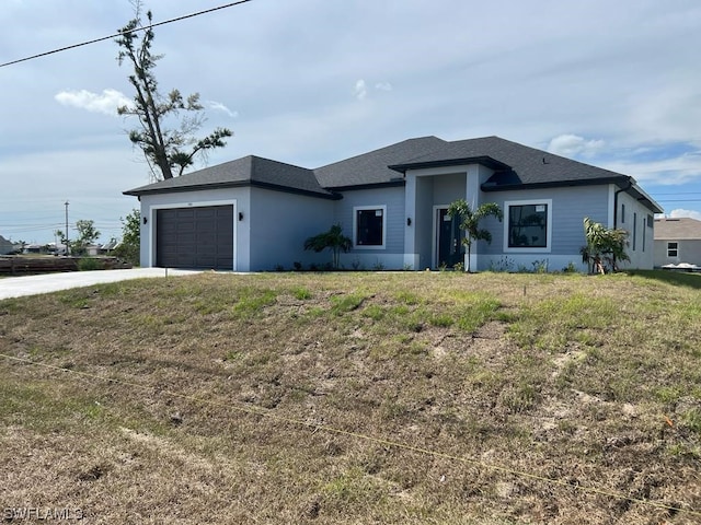 view of front of home with a front lawn and a garage