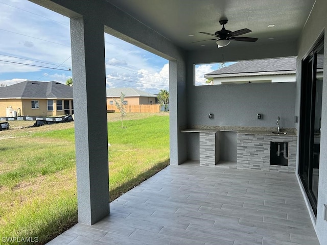 view of patio / terrace with ceiling fan and sink