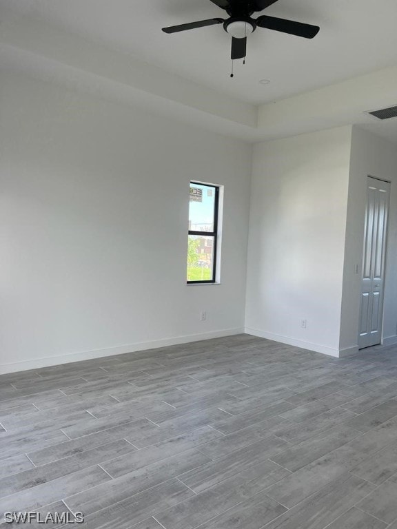 empty room with light hardwood / wood-style floors and ceiling fan