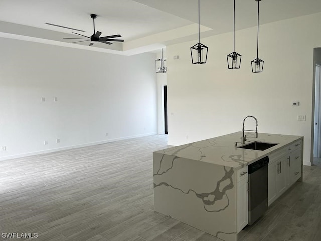 kitchen with hanging light fixtures, ceiling fan, sink, and light wood-type flooring