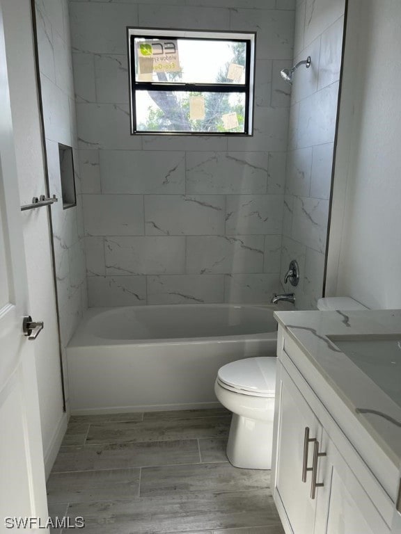 full bathroom featuring vanity, toilet, and tiled shower / bath