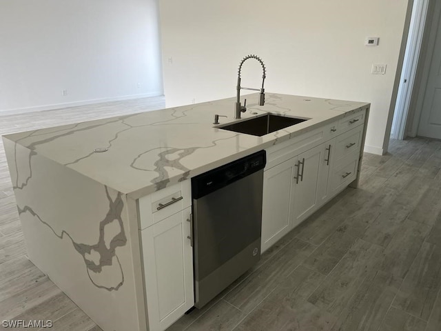 kitchen featuring white cabinets, sink, dishwasher, and light stone counters