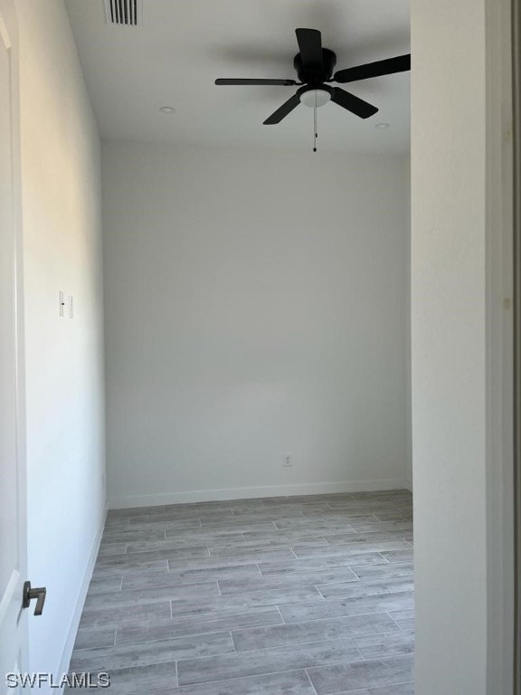 unfurnished room with ceiling fan and light wood-type flooring