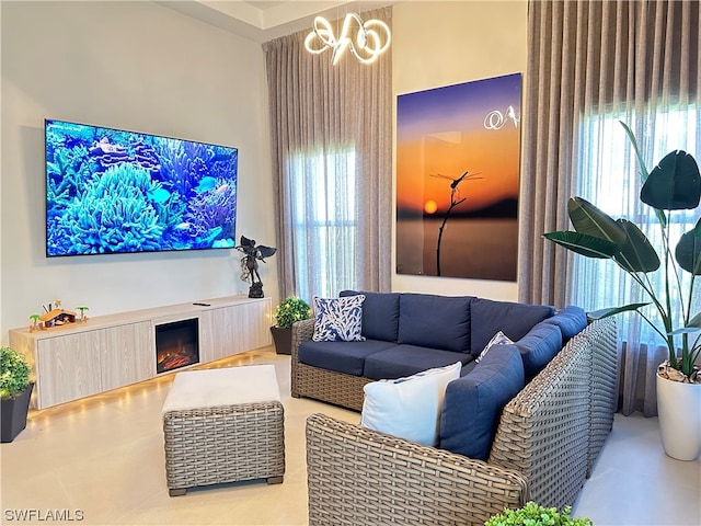 living room featuring a chandelier and light tile floors