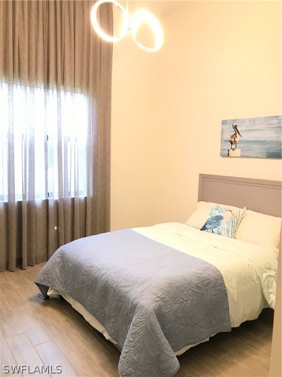 bedroom with wood-type flooring