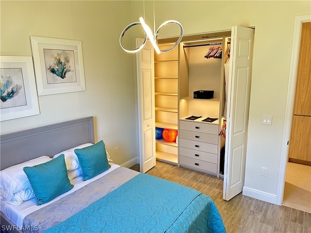 bedroom with a closet and light hardwood / wood-style floors