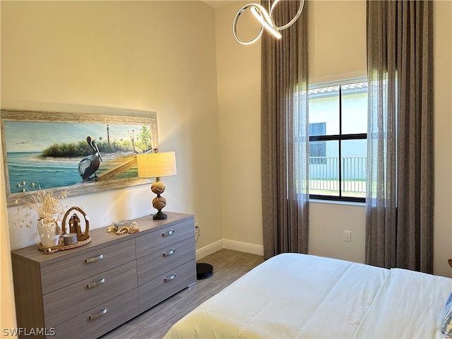 bedroom featuring hardwood / wood-style flooring and multiple windows