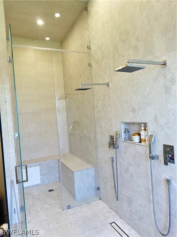 bathroom with a shower with door