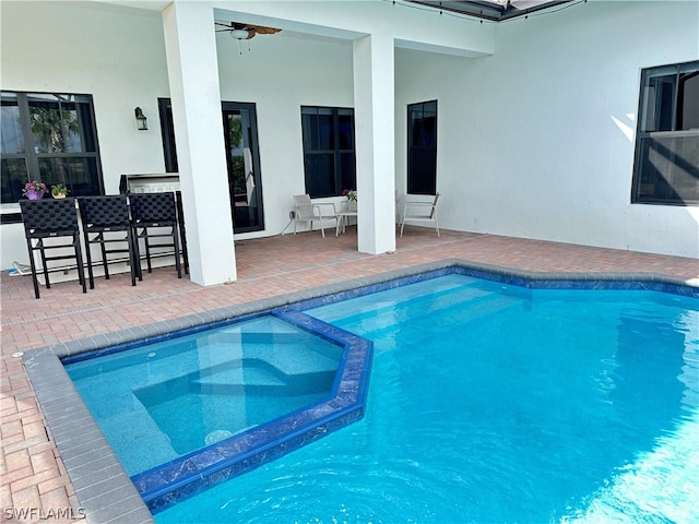 view of pool with a patio area and ceiling fan