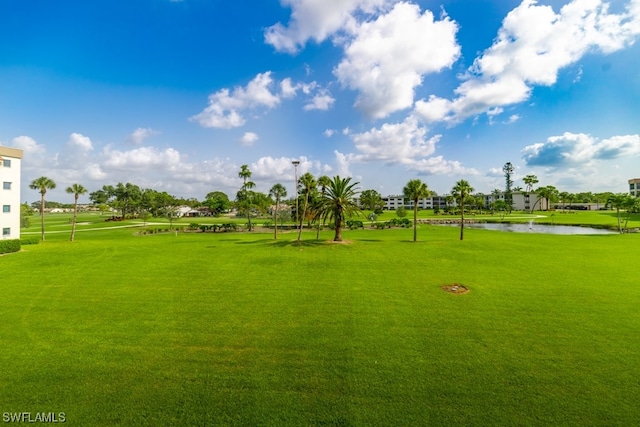 view of community with a yard and a water view