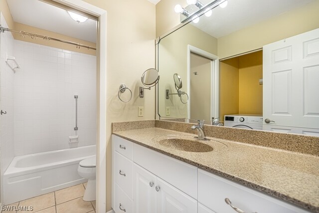 full bathroom with tile patterned floors, washer / clothes dryer,  shower combination, toilet, and vanity