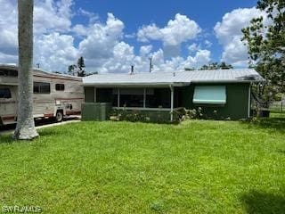 rear view of property with a lawn