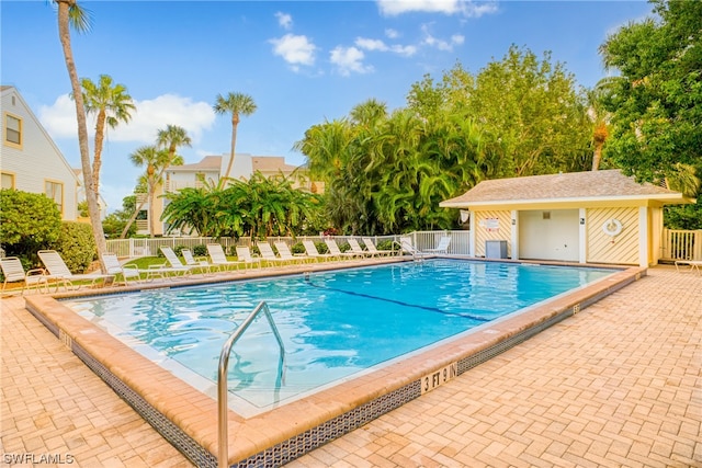 view of pool featuring an outdoor structure and a patio area