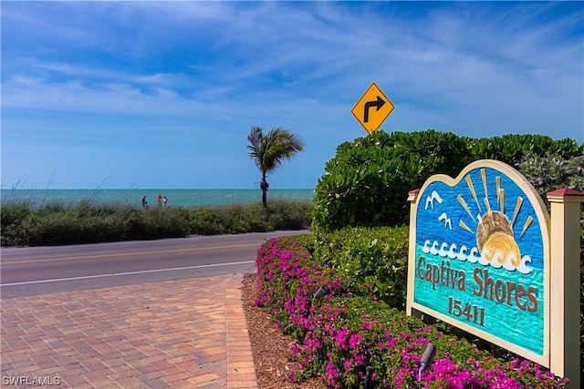 community sign featuring a water view