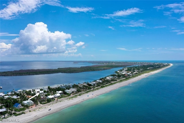 bird's eye view featuring a water view and a beach view