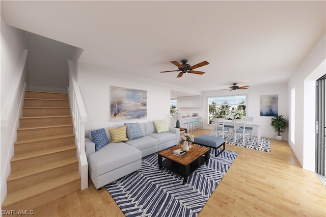 living room featuring light hardwood / wood-style floors and ceiling fan