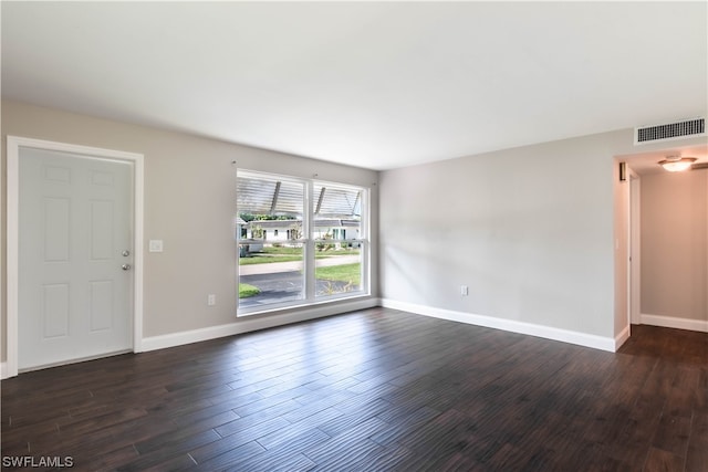 empty room with dark hardwood / wood-style floors