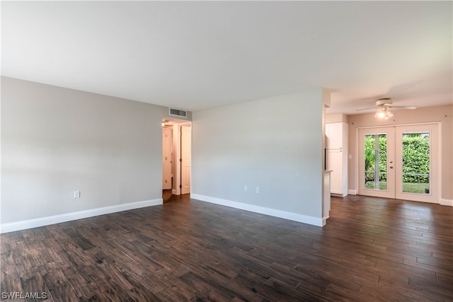 empty room featuring dark hardwood / wood-style floors, ceiling fan, and french doors