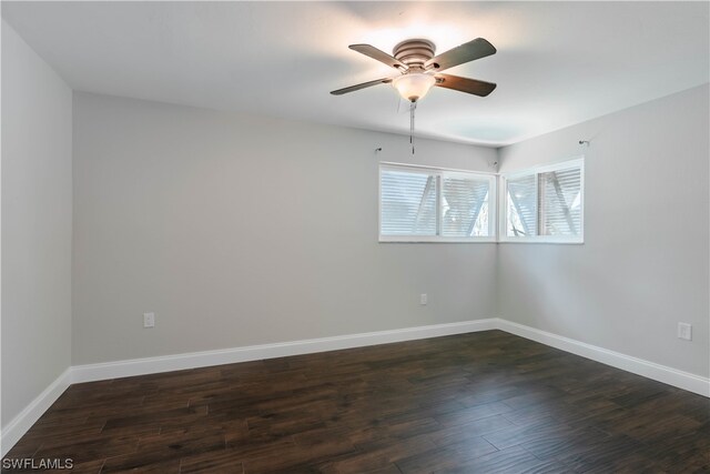 empty room featuring ceiling fan and dark hardwood / wood-style floors