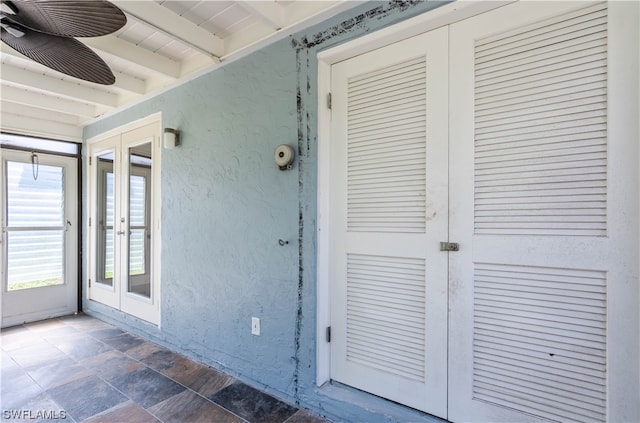 view of exterior entry featuring ceiling fan