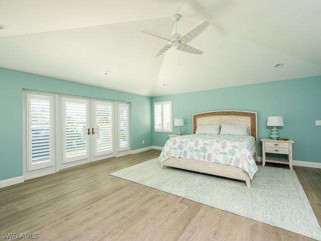 bedroom featuring hardwood / wood-style floors, ceiling fan, vaulted ceiling, and multiple windows