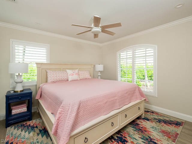 bedroom featuring ceiling fan, crown molding, and dark wood-type flooring