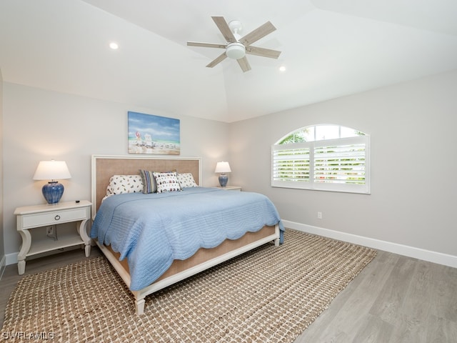 bedroom featuring lofted ceiling, light hardwood / wood-style floors, and ceiling fan