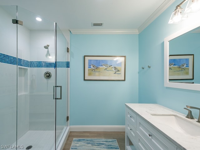 bathroom featuring ornamental molding, vanity, a shower with door, and hardwood / wood-style flooring