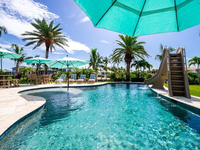 view of swimming pool with a water slide