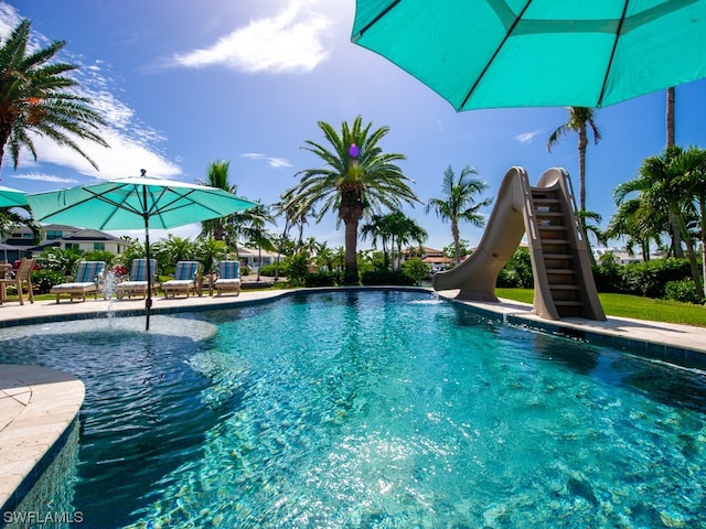 view of pool featuring pool water feature and a water slide