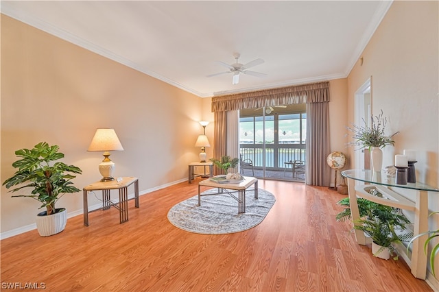 living area featuring ornamental molding, ceiling fan, and light hardwood / wood-style flooring