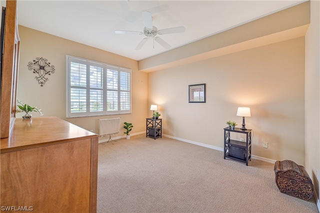 sitting room featuring light colored carpet and ceiling fan