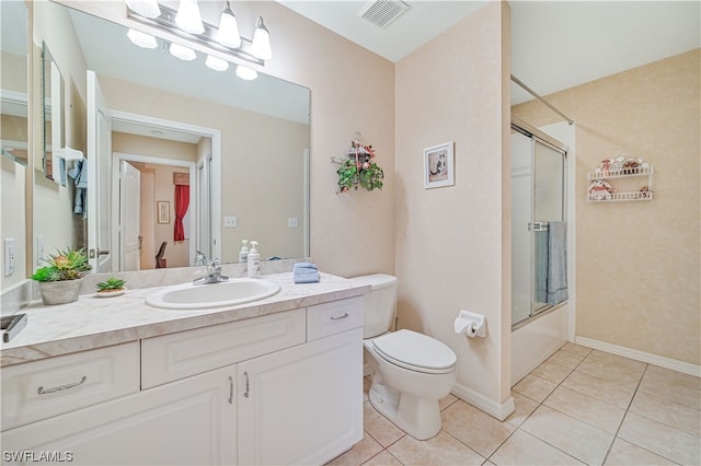 full bathroom featuring shower / bath combination with glass door, tile floors, oversized vanity, and toilet