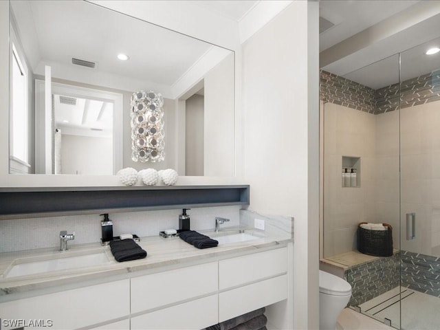 bathroom with vanity, a shower with shower door, and toilet