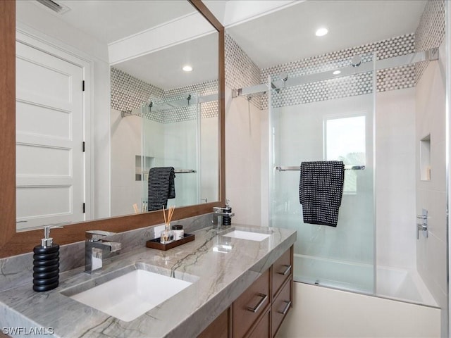 bathroom with vanity and bath / shower combo with glass door