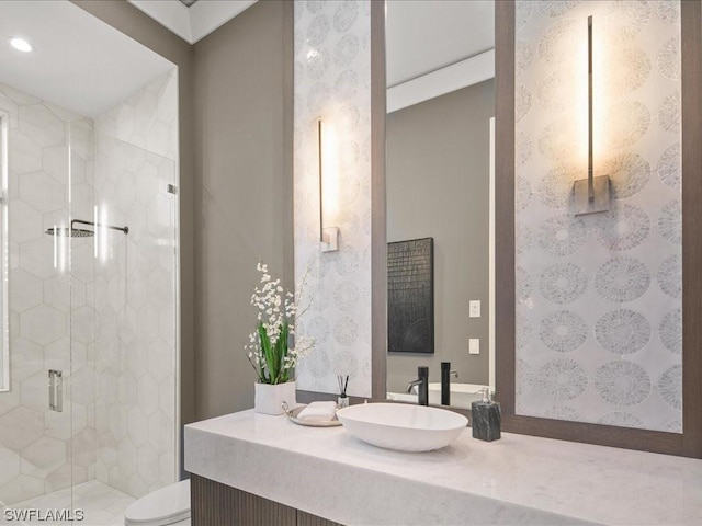 bathroom with vanity, a shower with door, and toilet