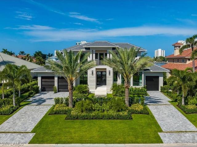 view of front of house featuring a garage and a front lawn