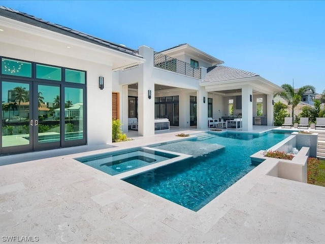 back of house featuring a pool with hot tub and a patio area