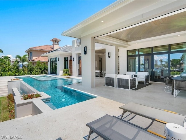 view of swimming pool with an in ground hot tub, outdoor lounge area, and a patio