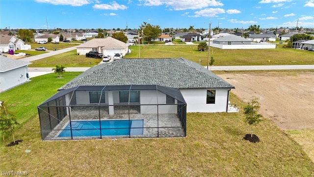 rear view of property featuring glass enclosure, a shingled roof, a residential view, and an outdoor pool