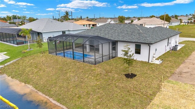 rear view of property with a shingled roof, an outdoor pool, a residential view, a lanai, and cooling unit