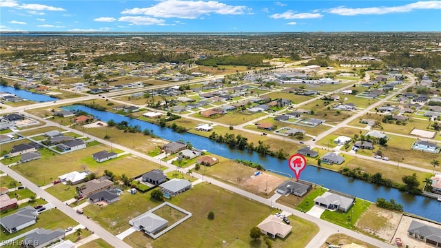 drone / aerial view with a residential view and a water view