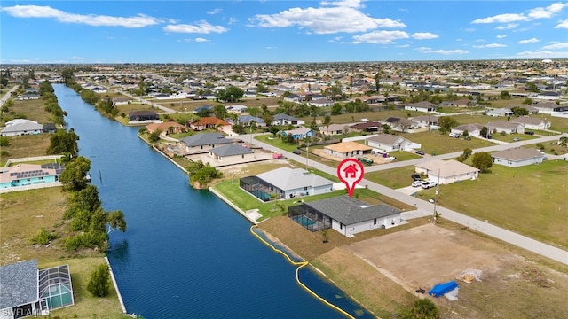 bird's eye view with a water view and a residential view