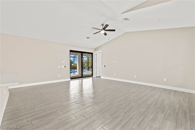 unfurnished room with vaulted ceiling, baseboards, visible vents, and a ceiling fan